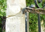 Decaying stonework and wrought iron at St Mary Tory chapel Gates, Bradford on Avon. Prior to restoration