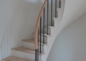 The curving bespoke stair balustrade complete with its oak handrail