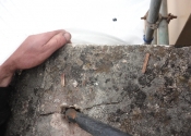Stone damage where the freeze-thaw effect of metal in stone has weakened the stonework